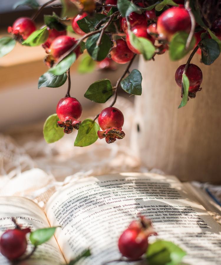 A vibrant 12-inch tall artificial pomegranate fruit bouquet featuring realistic red pomegranates and green leaves, perfect for home decor.