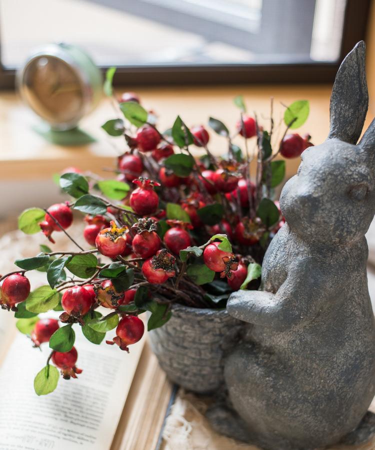 A vibrant 12-inch tall artificial pomegranate fruit bouquet featuring realistic red pomegranates and green leaves, perfect for home decor.