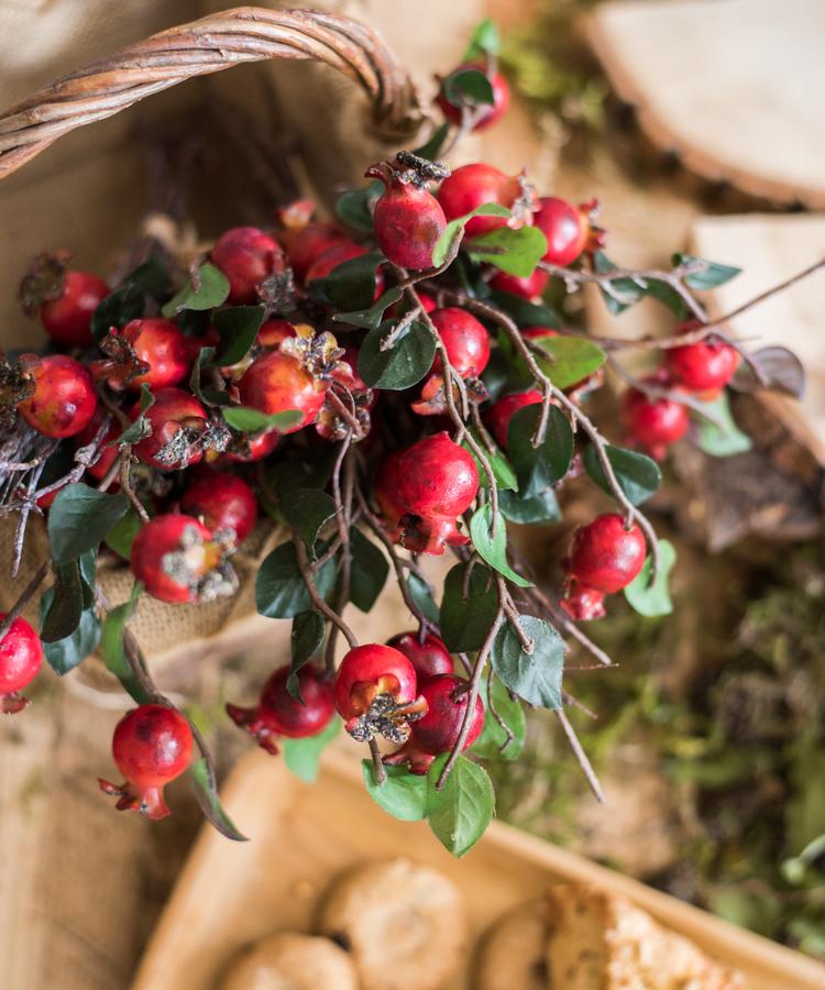 A vibrant 12-inch tall artificial pomegranate fruit bouquet featuring realistic red pomegranates and green leaves, perfect for home decor.