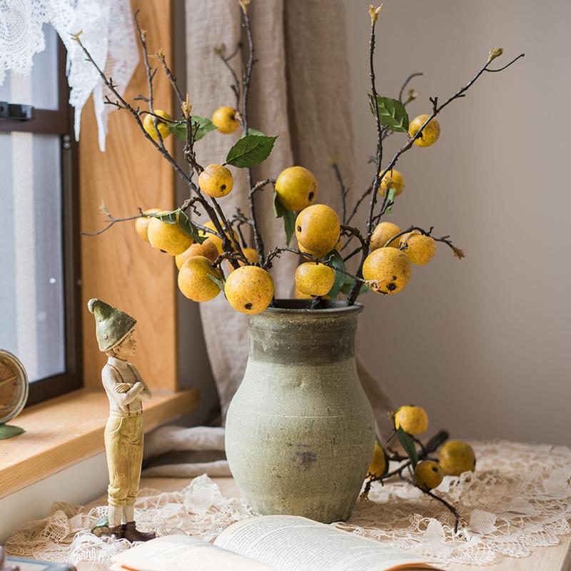 A 27-inch tall artificial fruit stem featuring four realistic yellow apple pears with green accents, perfect for home decor.