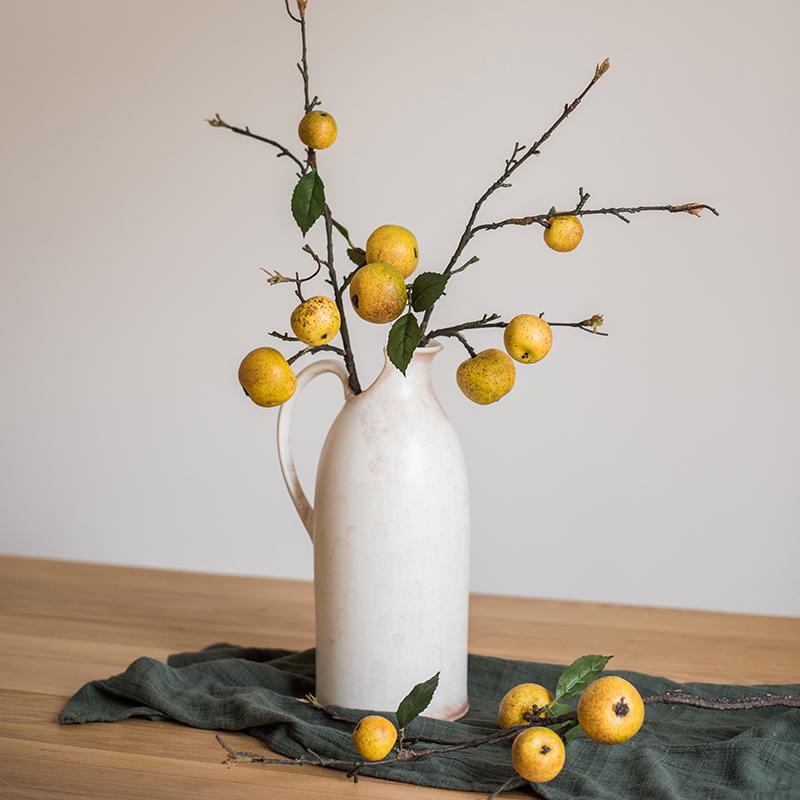 A 27-inch tall artificial fruit stem featuring four realistic yellow apple pears with green accents, perfect for home decor.