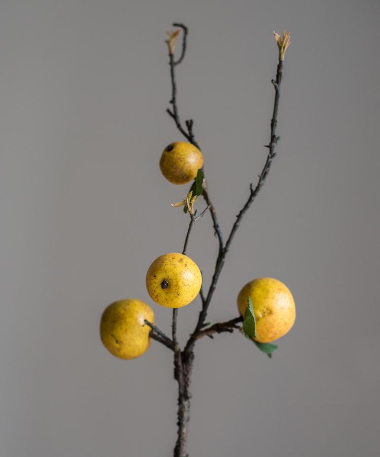 A 27-inch tall artificial fruit stem featuring four realistic yellow apple pears with green accents, perfect for home decor.