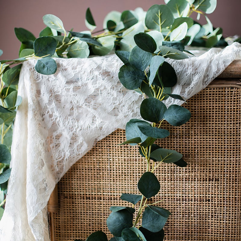 A long artificial green eucalyptus vine, 70 inches, with realistic silk leaves, perfect for home and event decor.