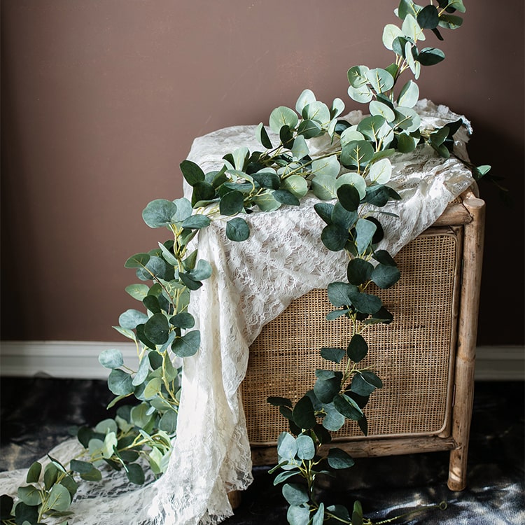 A long artificial green eucalyptus vine, 70 inches, with realistic silk leaves, perfect for home and event decor.