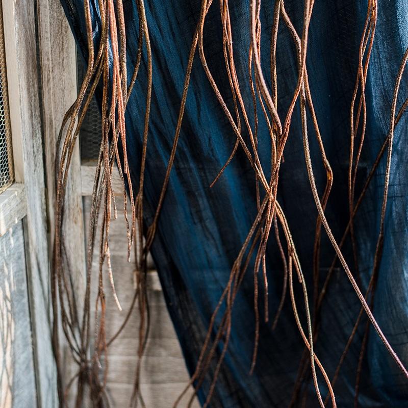 A bundle of 65-inch long artificial hanging willow branches in a natural brown color, showcasing realistic leaves and a lifelike appearance.