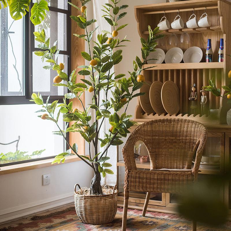 A realistic artificial lemon tree in a black pot, featuring vibrant green leaves and bright yellow lemons, perfect for home decor.