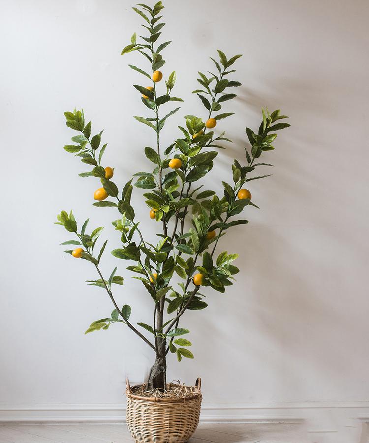 A realistic artificial lemon tree in a black pot, featuring vibrant green leaves and bright yellow lemons, perfect for home decor.