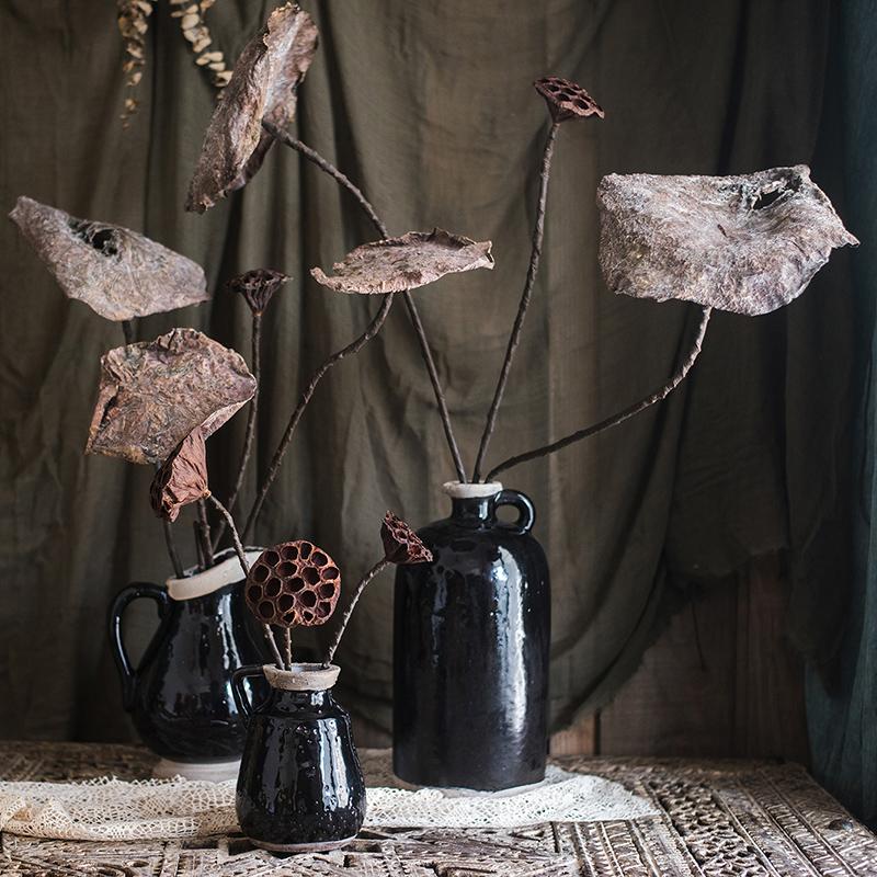 A beautifully arranged display of artificial lotus dried leaves and pods in natural brown tones, showcasing their elegant design.