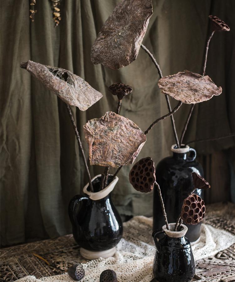 A beautifully arranged display of artificial lotus dried leaves and pods in natural brown tones, showcasing their elegant design.