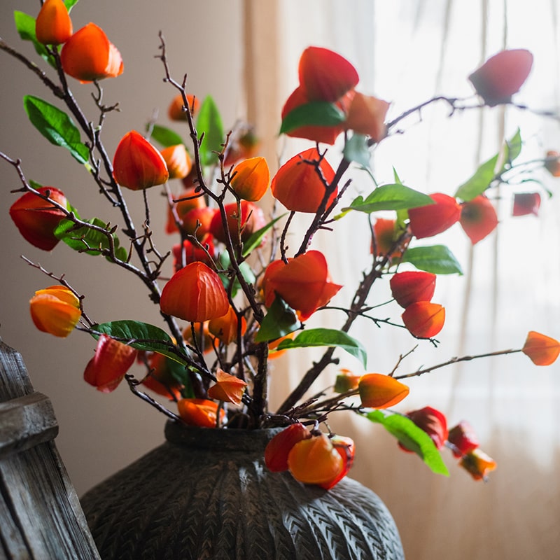 Artificial Makino Fruit Stem in vibrant orange-red, 39 inches tall, featuring realistic silk leaves and fruit.