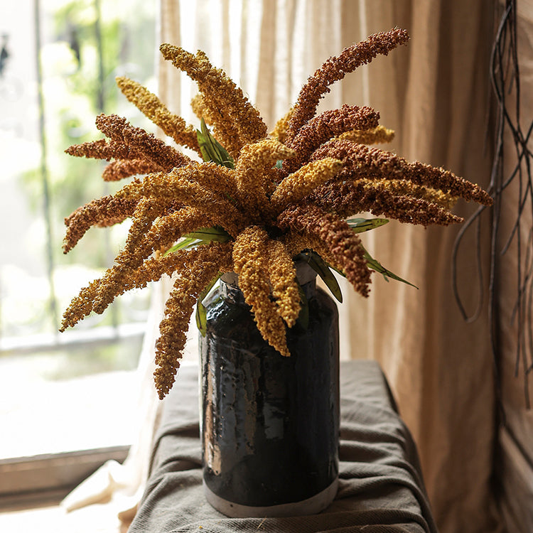 A 19-inch tall artificial millet bundle featuring vibrant brown, orange-brown, yellow, and green leaves, perfect for home decor.