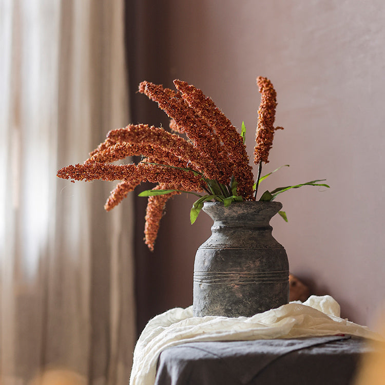 A 19-inch tall artificial millet bundle featuring vibrant brown, orange-brown, yellow, and green leaves, perfect for home decor.