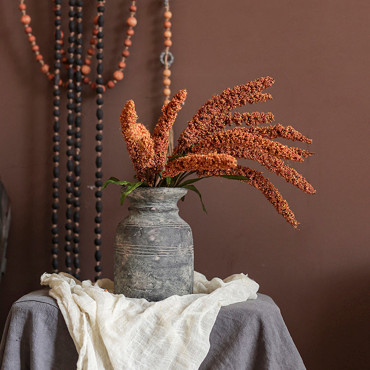 A 19-inch tall artificial millet bundle featuring vibrant brown, orange-brown, yellow, and green leaves, perfect for home decor.