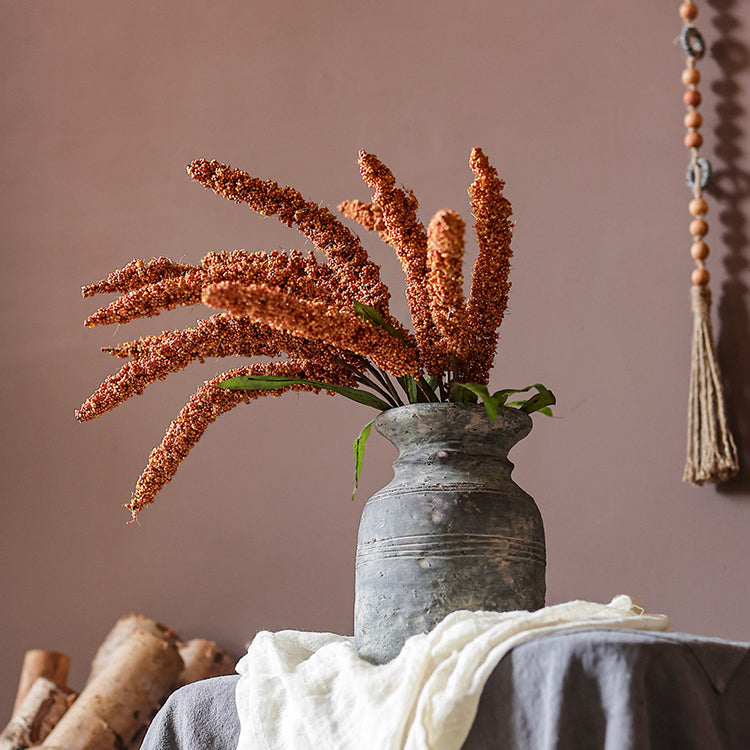 A 19-inch tall artificial millet bundle featuring vibrant brown, orange-brown, yellow, and green leaves, perfect for home decor.