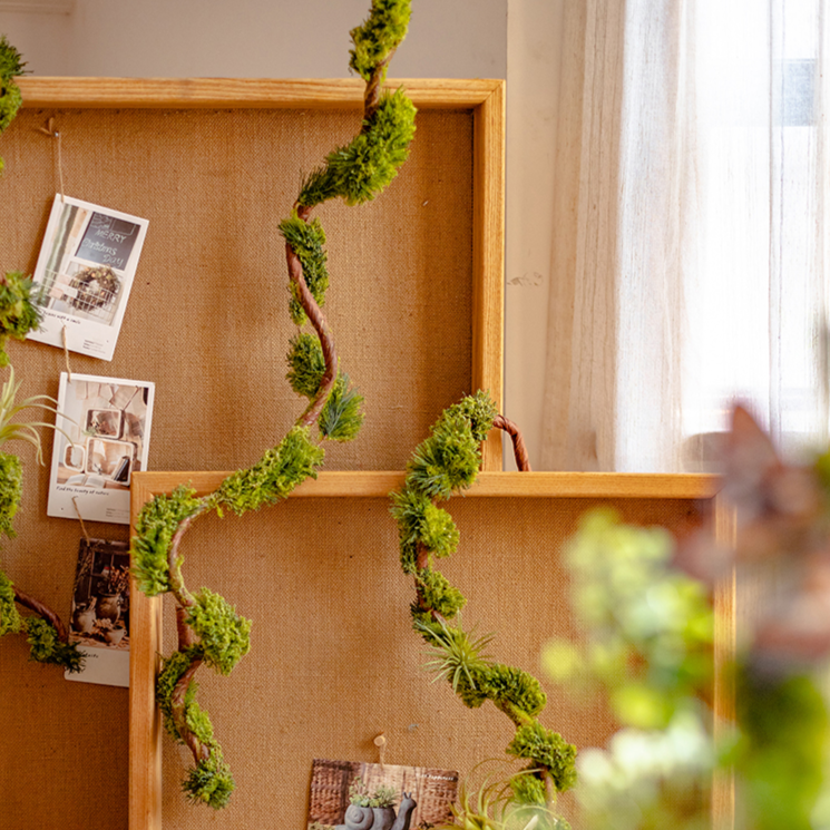 Artificial Moss Rattan Vine in green and brown, showcasing its realistic faux moss and rattan design, perfect for home decor.