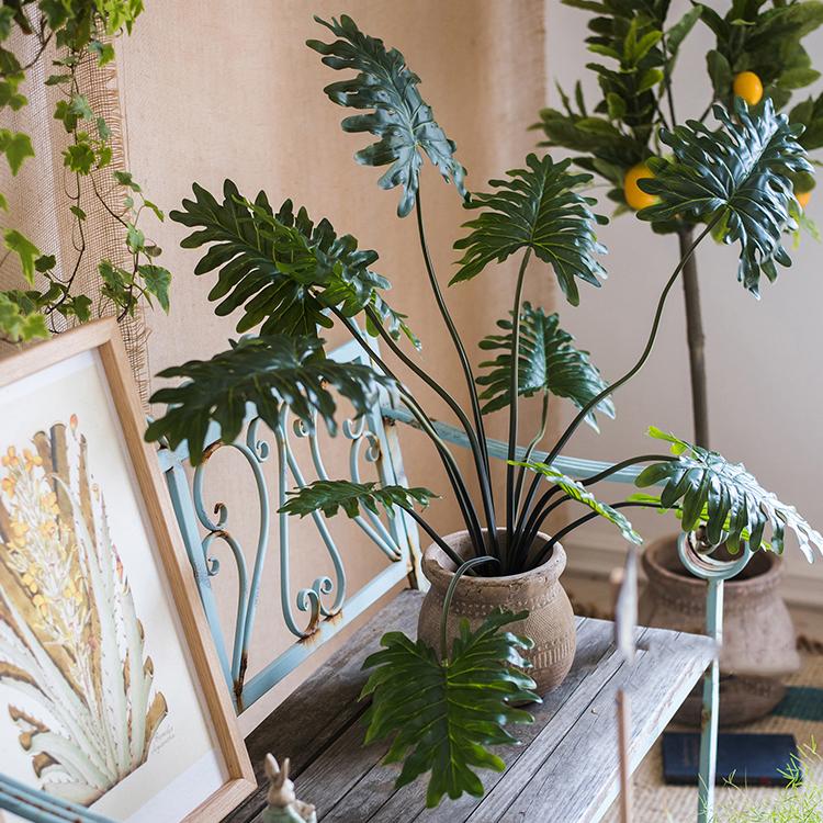 A 31-inch tall artificial Philodendron plant in a black pot, showcasing realistic green leaves and a lifelike appearance.