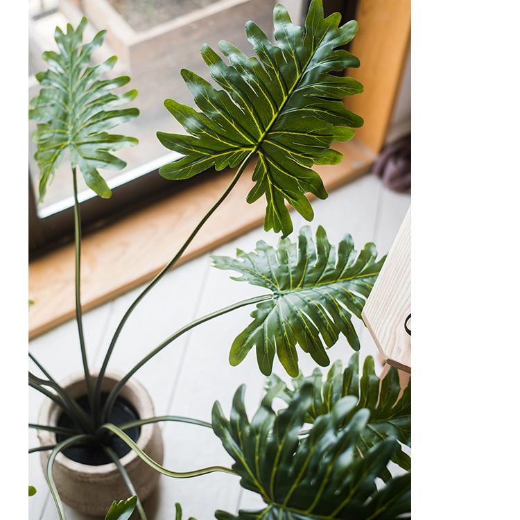 A 31-inch tall artificial Philodendron plant in a black pot, showcasing realistic green leaves and a lifelike appearance.