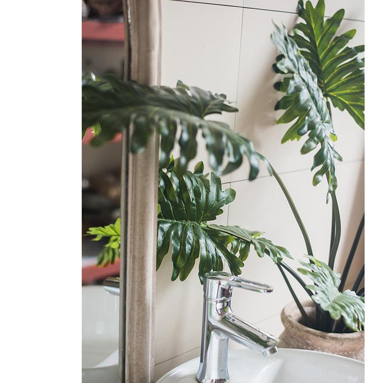 A 31-inch tall artificial Philodendron plant in a black pot, showcasing realistic green leaves and a lifelike appearance.