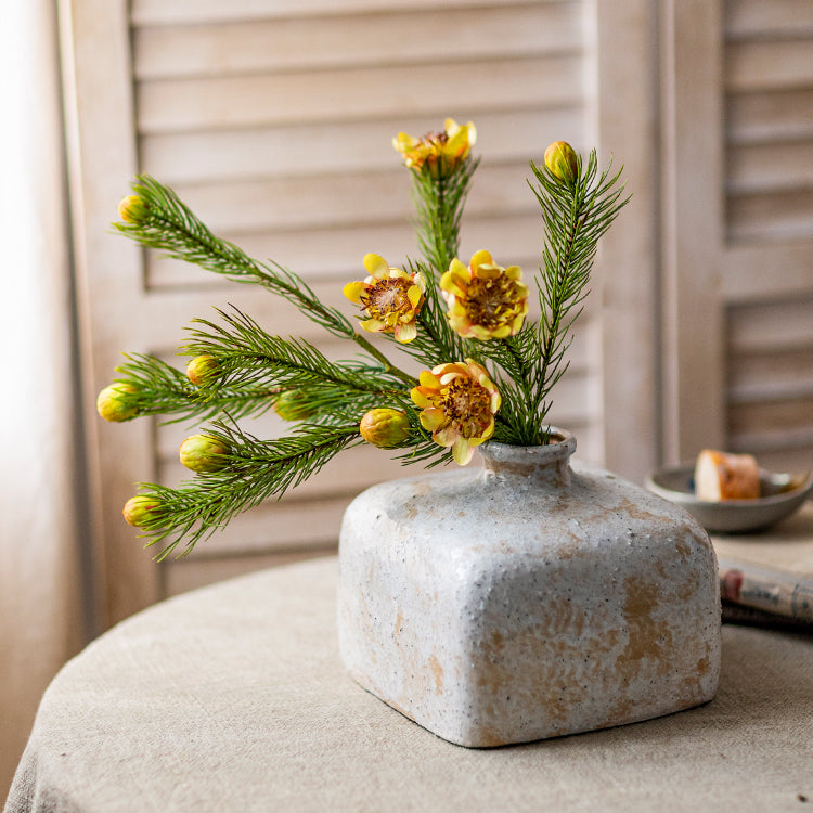 A 26-inch tall artificial pine needle flower stem in mixed colors, showcasing realistic details and vibrant hues.