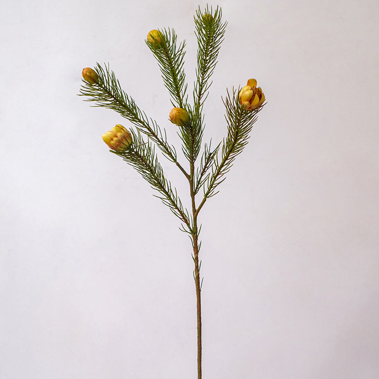 A 26-inch tall artificial pine needle flower stem in mixed colors, showcasing realistic details and vibrant hues.