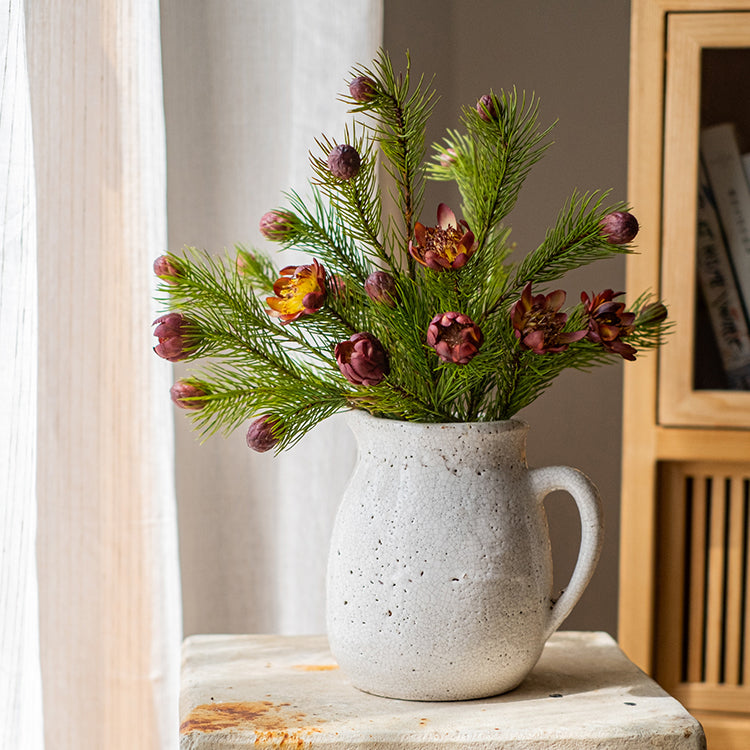 A 26-inch tall artificial pine needle flower stem in mixed colors, showcasing realistic details and vibrant hues.