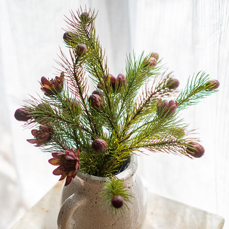 A 26-inch tall artificial pine needle flower stem in mixed colors, showcasing realistic details and vibrant hues.