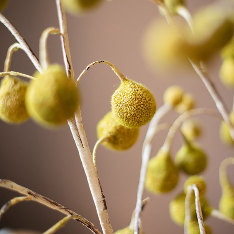 A tall 48-inch artificial Plane Tree fruit stem with vibrant yellow color, showcasing realistic fruit details and lush foliage.