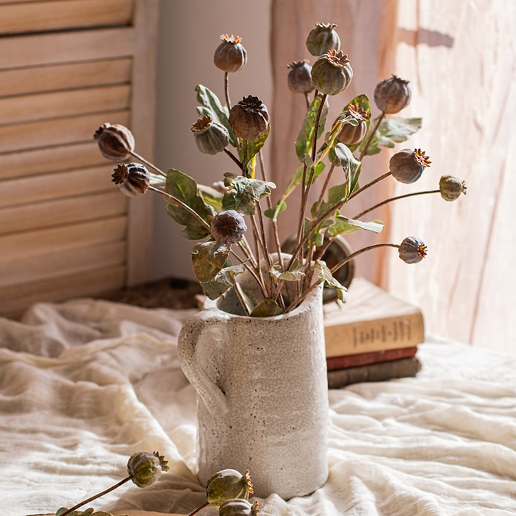 A 23.6-inch tall artificial poppy fruit stem with vibrant frosted green, purple, and yellow colors, featuring four realistic fruits on a sturdy stem.