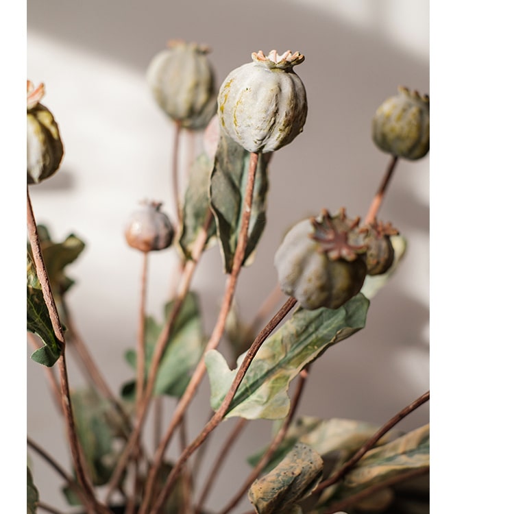 A 23.6-inch tall artificial poppy fruit stem with vibrant frosted green, purple, and yellow colors, featuring four realistic fruits on a sturdy stem.