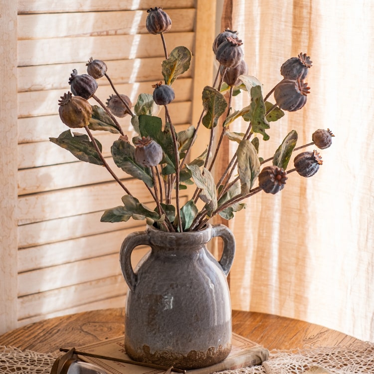 A 23.6-inch tall artificial poppy fruit stem with vibrant frosted green, purple, and yellow colors, featuring four realistic fruits on a sturdy stem.