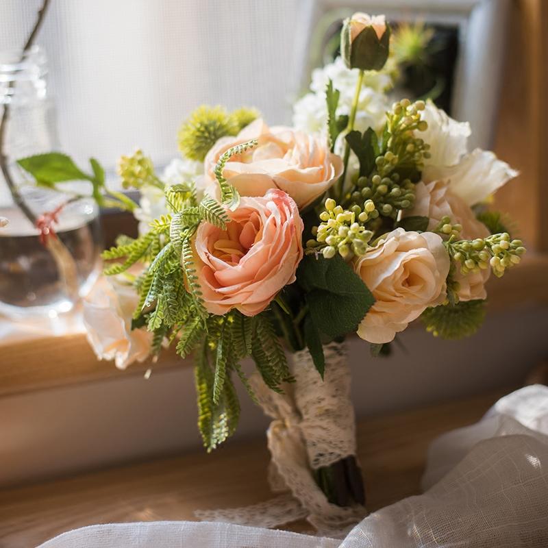 A beautiful 12-inch tall artificial silk flower bouquet featuring champagne roses, dahlias, and greenery, perfect for home decor and events.