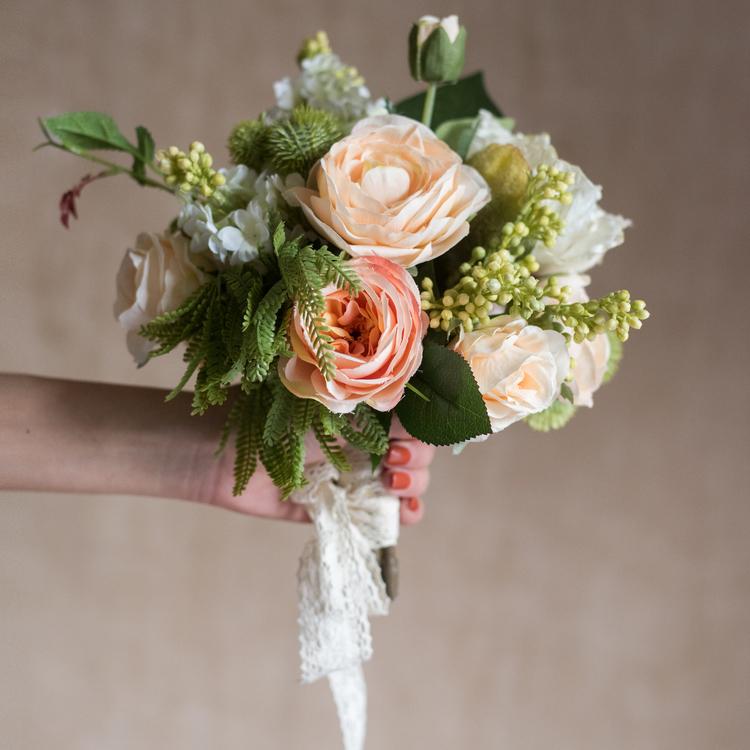 A beautiful 12-inch tall artificial silk flower bouquet featuring champagne roses, dahlias, and greenery, perfect for home decor and events.