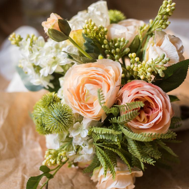 A beautiful 12-inch tall artificial silk flower bouquet featuring champagne roses, dahlias, and greenery, perfect for home decor and events.