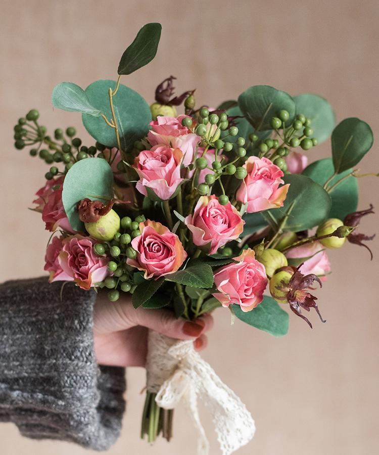 A beautiful 12-inch tall artificial silk flower bouquet featuring pink roses and lush greenery, perfect for home decor.