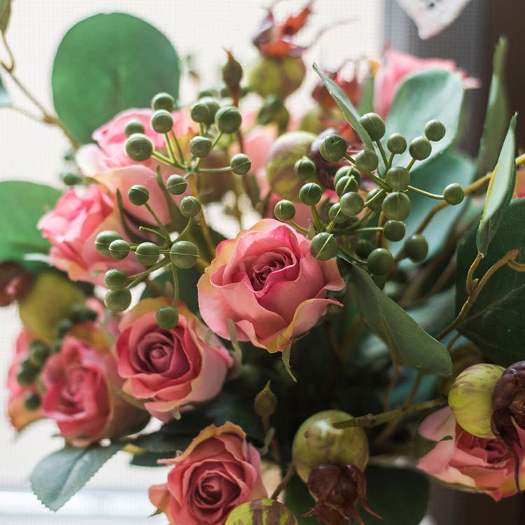 A beautiful 12-inch tall artificial silk flower bouquet featuring pink roses and lush greenery, perfect for home decor.