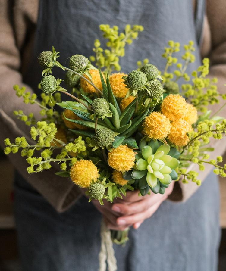 A vibrant 13-inch tall artificial silk flower bouquet featuring yellow dahlias and lush green leaves, perfect for spring decor.