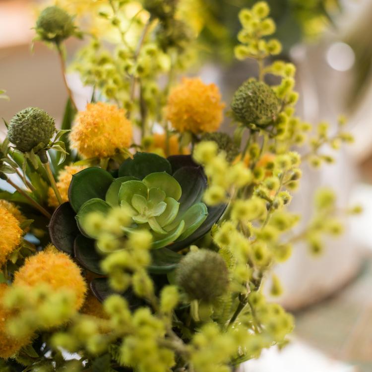 A vibrant 13-inch tall artificial silk flower bouquet featuring yellow dahlias and lush green leaves, perfect for spring decor.