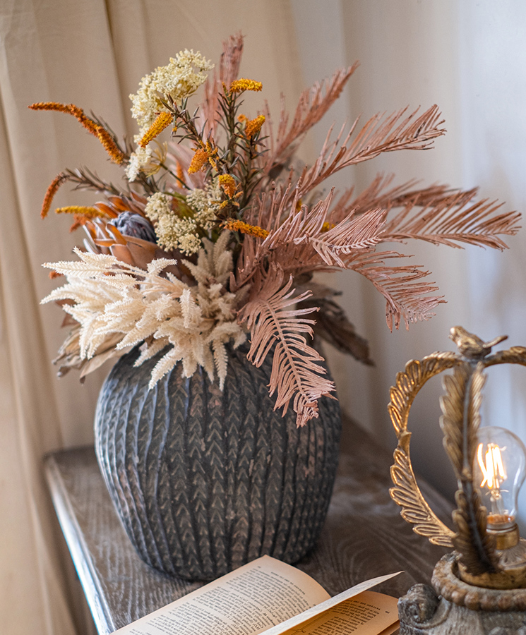 A beautifully arranged Artificial Silk Natural Fall Designer Flower Bouquet featuring protea and fern plants in white, purple, and light brown colors.