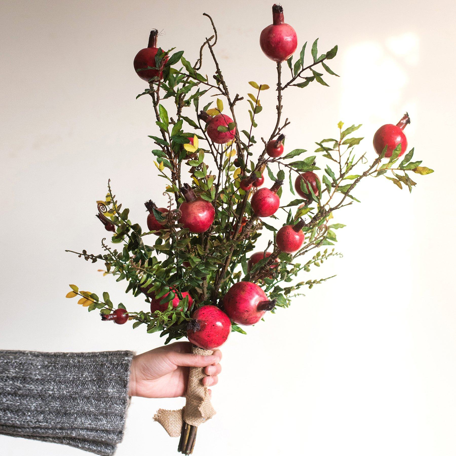 A vibrant 22-inch tall artificial silk bouquet featuring realistic red pomegranate fruits and lush green leaves, perfect for home decor.