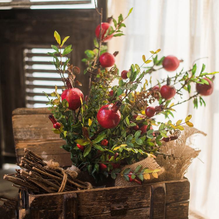 A vibrant 22-inch tall artificial silk bouquet featuring realistic red pomegranate fruits and lush green leaves, perfect for home decor.