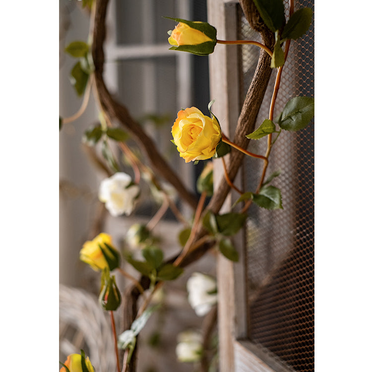 A 55-inch long artificial silk rose vine featuring vibrant pink, purple, white, and red roses, perfect for indoor and outdoor decoration.