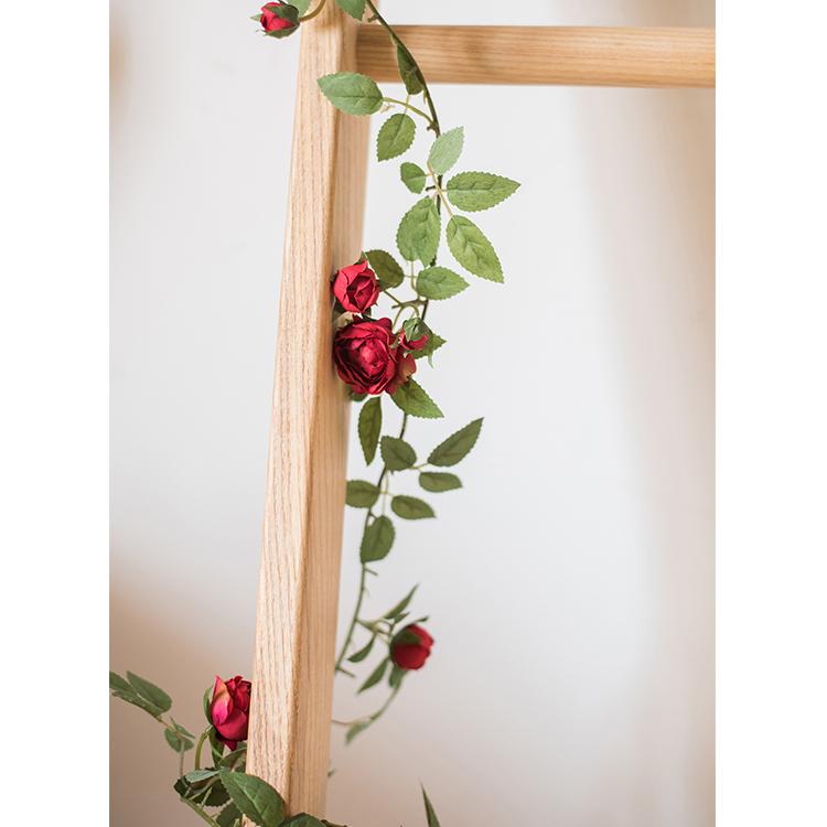 A 57-inch long artificial silk rose vine featuring small roses in pink, purple, white, and red, perfect for home decor.