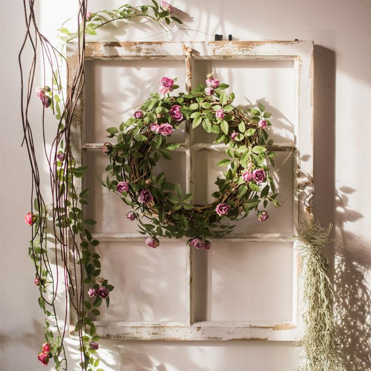 A 57-inch long artificial silk rose vine featuring small roses in pink, purple, white, and red, perfect for home decor.