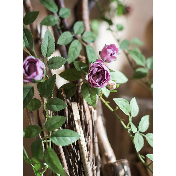 A 57-inch long artificial silk rose vine featuring small roses in pink, purple, white, and red, perfect for home decor.