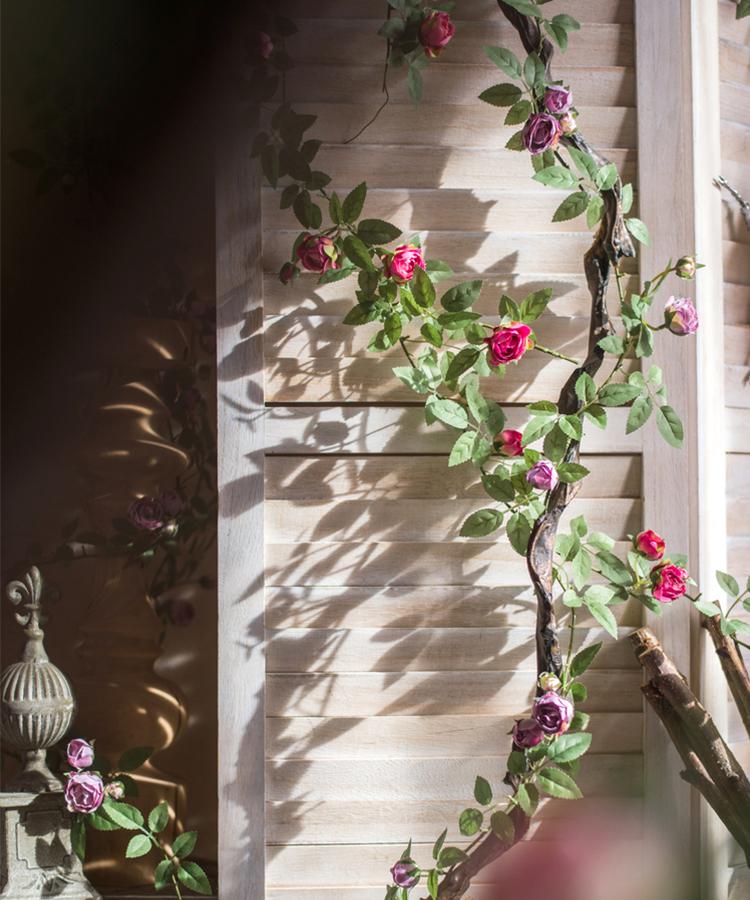 A 57-inch long artificial silk rose vine featuring small roses in pink, purple, white, and red, perfect for home decor.