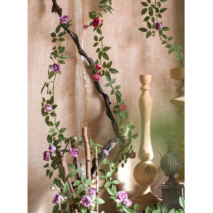 A 57-inch long artificial silk rose vine featuring small roses in pink, purple, white, and red, perfect for home decor.