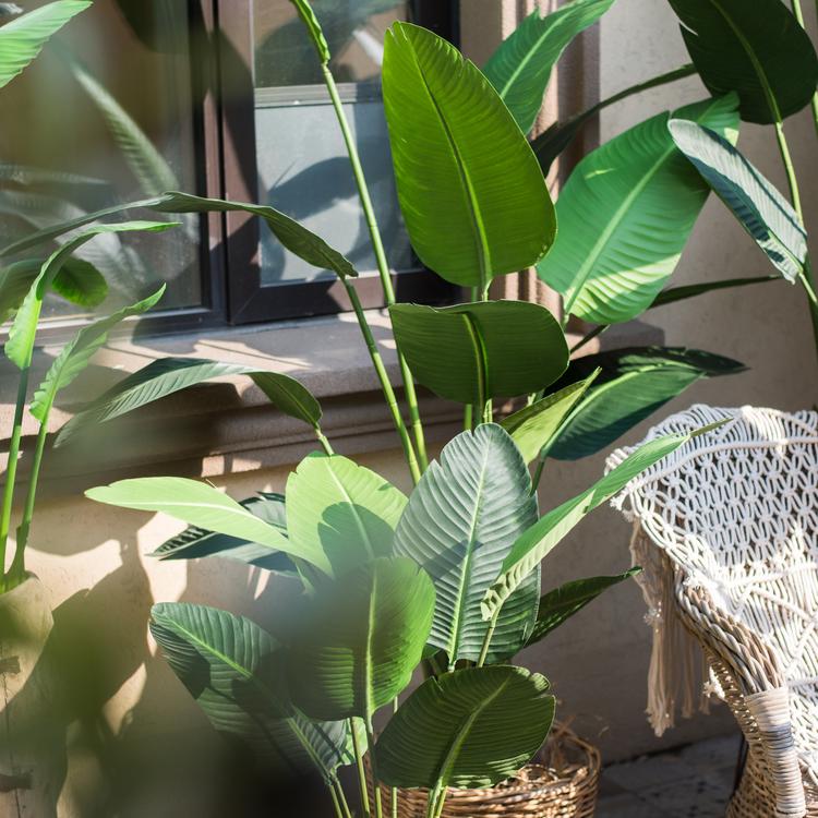 Artificial Silk Travelers Palm Tree in Pot, showcasing lush green leaves and a stylish black pot.