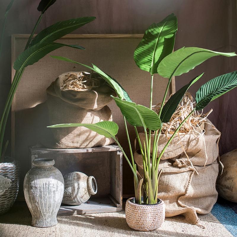 Artificial Silk Travelers Palm Tree in Pot, showcasing lush green leaves and a stylish black pot.