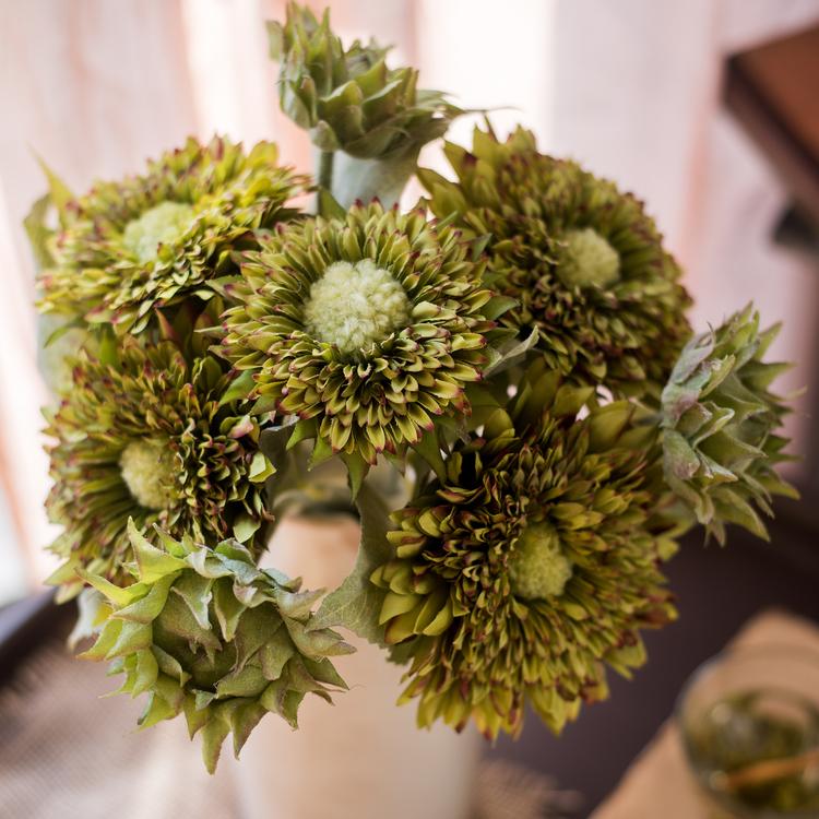 A vibrant artificial sunflower bouquet featuring five flower stems and three bud stems in green and orange colors, standing 18 inches tall.