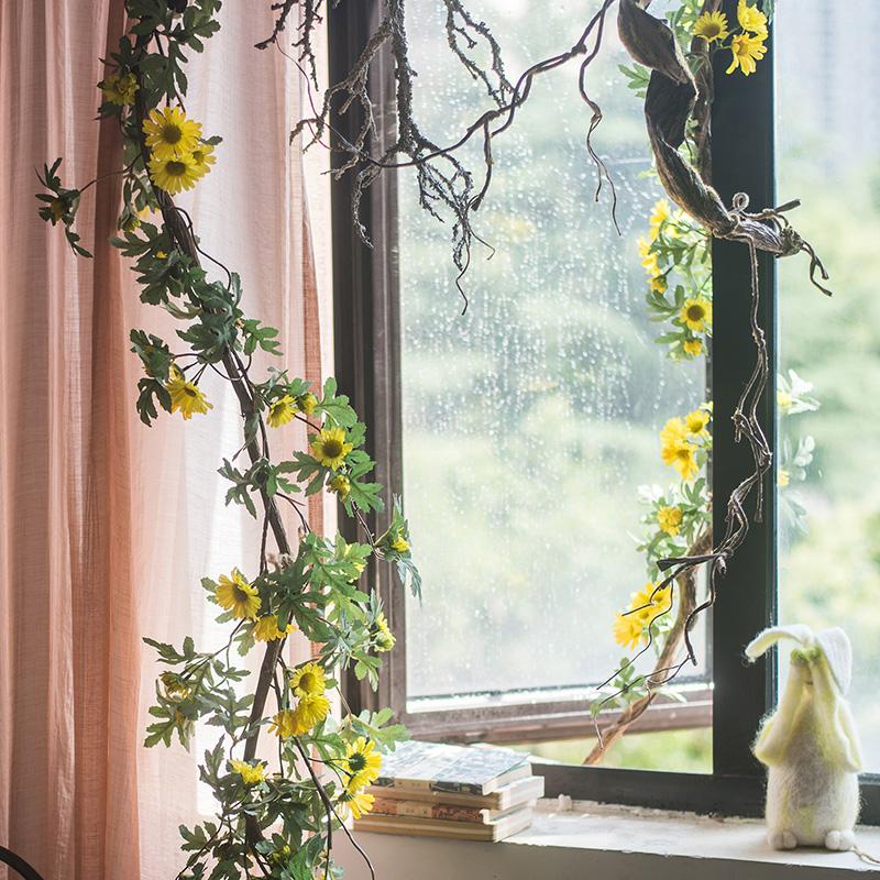 A long artificial sunflower vine featuring vibrant yellow sunflowers and lush green leaves, perfect for home decor.